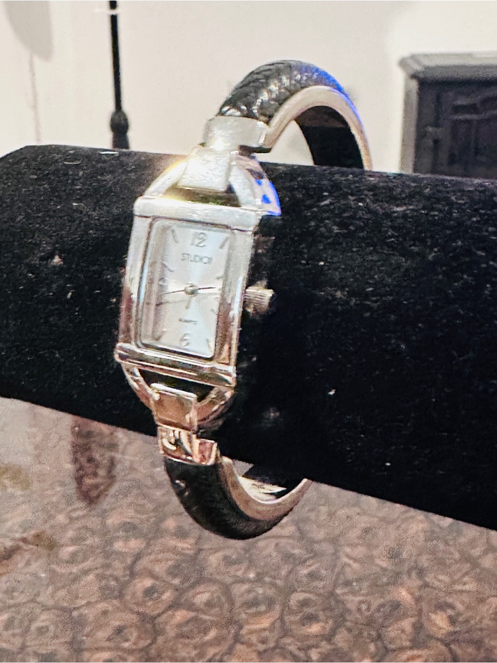 Studio time analog watch with braided bracelet band.